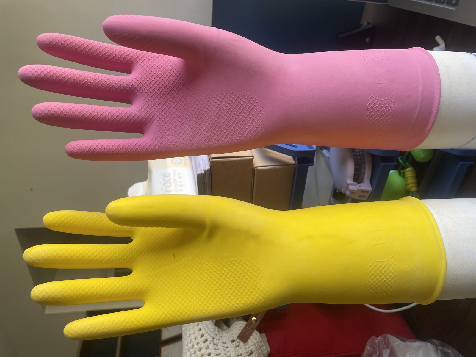 Close-up of fish-scale non-slip grip texture on latex household glove palm